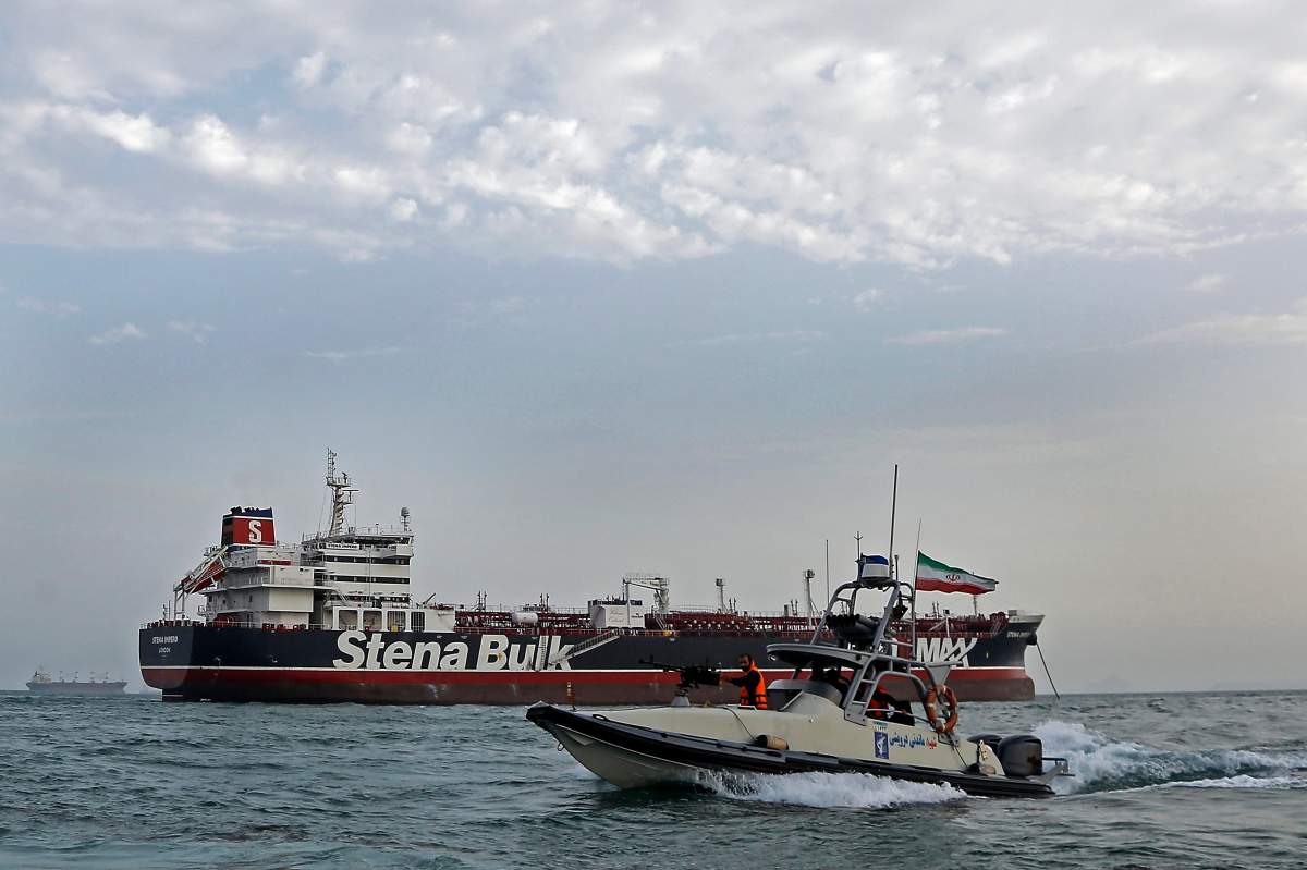 An Iranian Revolutionary Guard jet boat sails around the seized British-flagged tanker Stena Impero in Bandar Abbas, southern Iran, July 21, 2019. 