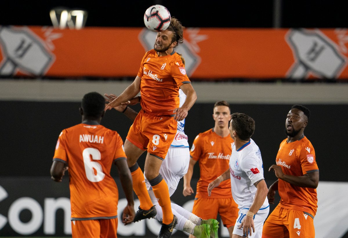 Hamilton Forge FC's Giuliano Frano (8) heads the ball against CD Olimpia's Jorge Benguche (9) during Scotiabank CONCACAF League 2019 second half soccer action in Hamilton on Thursday, August 22, 2019. 