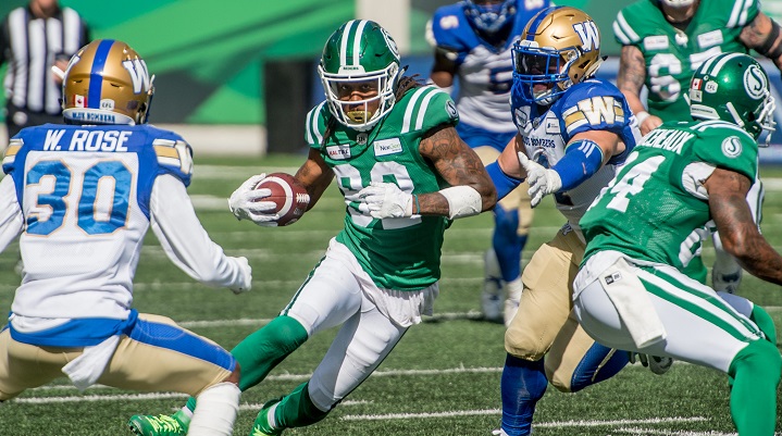 Saskatchewan Roughriders wide receiver Naaman Roosevelt (82) runs the ball under pressure from the Winnipeg Blue Bombers defence during second half CFL action in Regina in the Labour Day Classic. The Saskatchewan Roughriders defeated the Winnipeg Blue Bombers 19-17 on Sept 1, 2019.