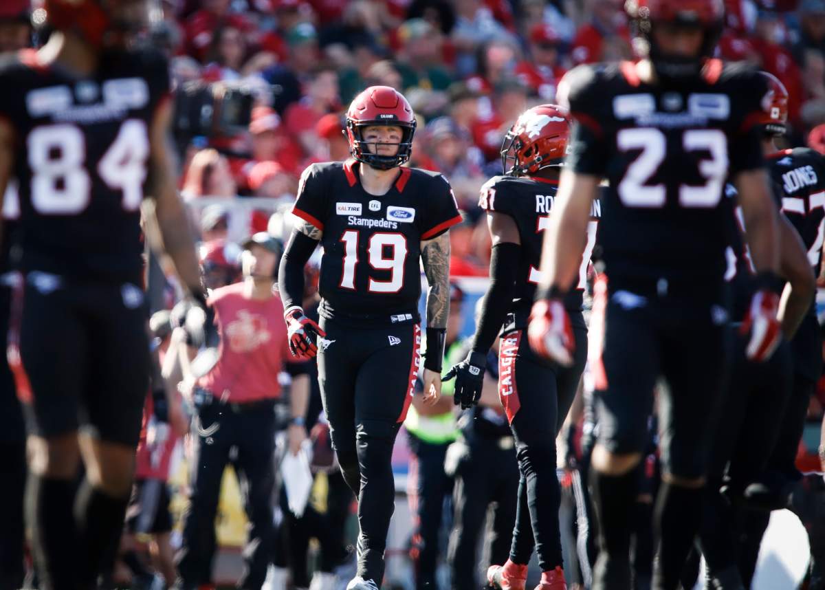 Calgary Stampeders' quarterback Bo Levi Mitchell walks onto the field during second half CFL football action against the Edmonton Eskimos, in Calgary, Monday, Sept. 2, 2019. 
