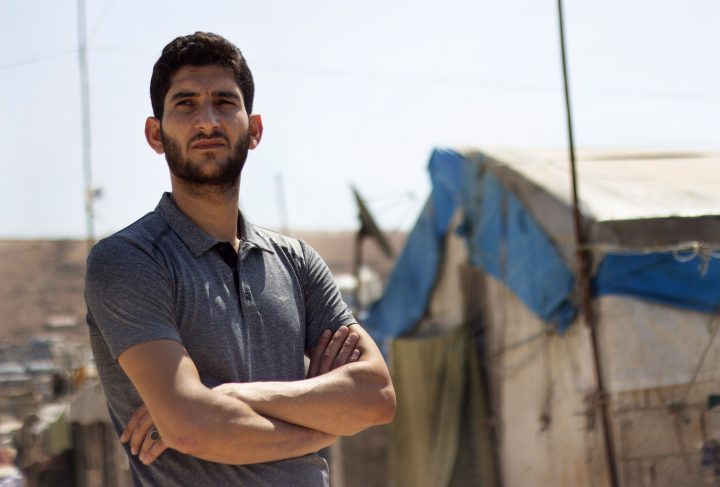 In this Sunday Sept. 1, 2019 photo, Syrian Abdel Hamid al-Yousef poses for a picture, at a displaced settlement near the Turkish border.