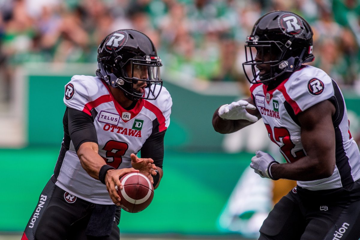 Ottawa Redblacks quarterback Jonathon Jennings (3) hands the ball off to teammate Greg Morris (22) during first half CFL action against the Saskatchewan Roughriders, in Regina, Saturday, Aug. 24, 2019. The Redblacks are promoting Jennings to starting quarterback.The Redblacks (3-7) will replace the struggling Dominique Davis with Jennings when they return to action on Saturday against the visiting Toronto Argonauts.