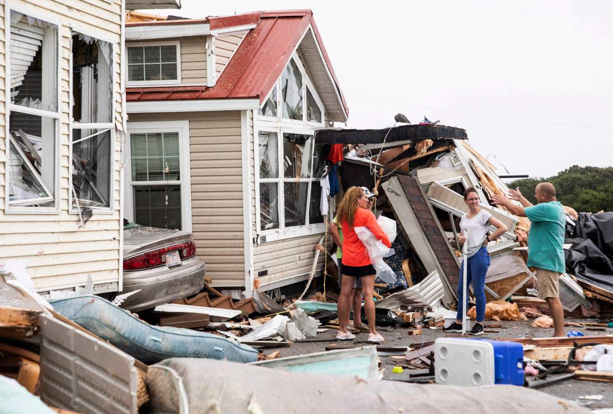 Residents of the Boardwalk RV Park discuss the path of a possible waterspout or tornado, generated by hurricane Dorian, struck the area in Emerald Isle, N.C. (The Associated Press)