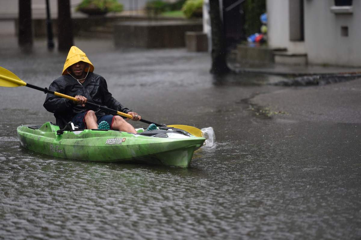 Johnny Crawford navigates his kayak down a flooded street, Thursday, Sept. 5, 2019, in Charleston, S.C., following hurricane Dorian. (The Associated Press)