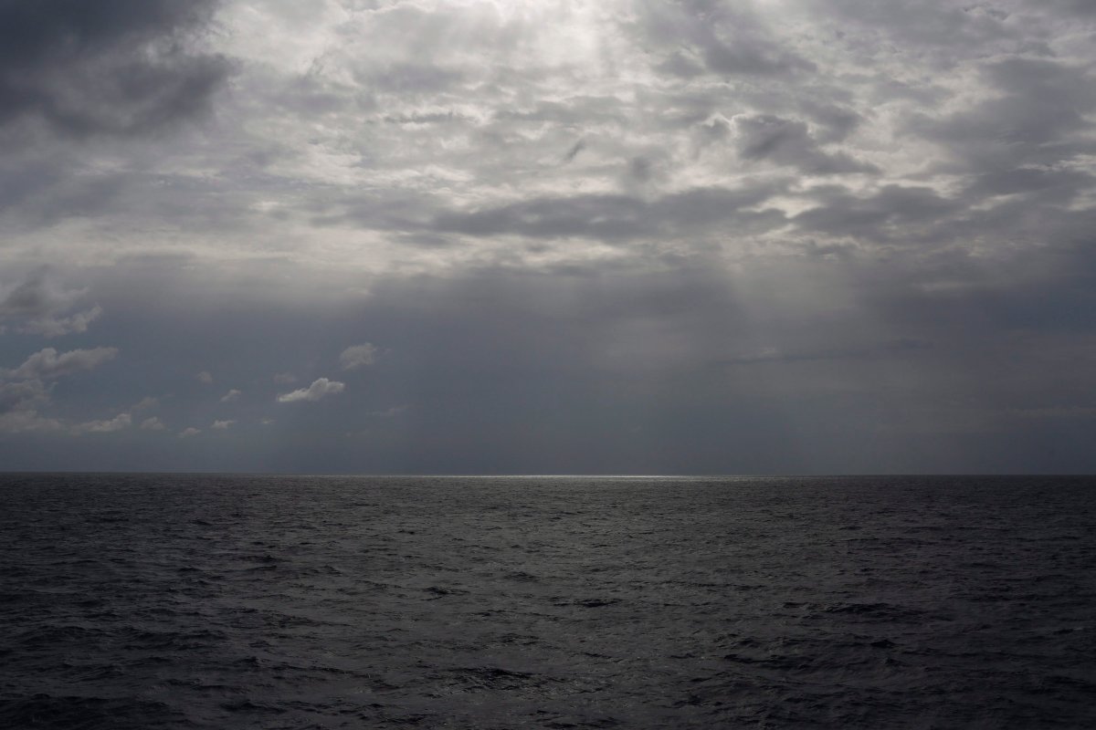 In this file photo taken on Sunday, Sept. 8, 2019, the sun pierces the clouds over international waters north of Libya in the Mediterranean Sea. 