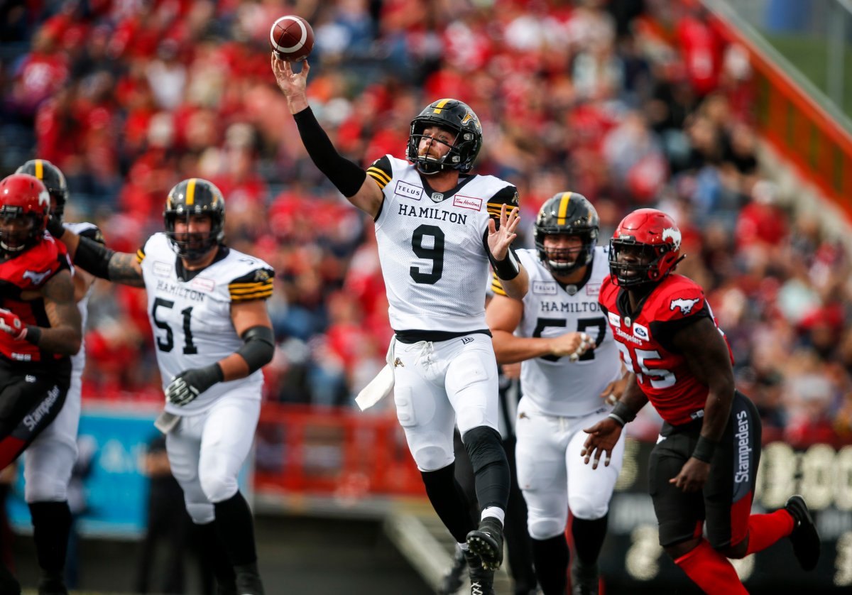 Hamilton Tiger-Cats quarterback Dane Evans, centre, throws the ball during first half CFL football action against the Calgary Stampeders in Calgary, Saturday, Sept. 14, 2019.