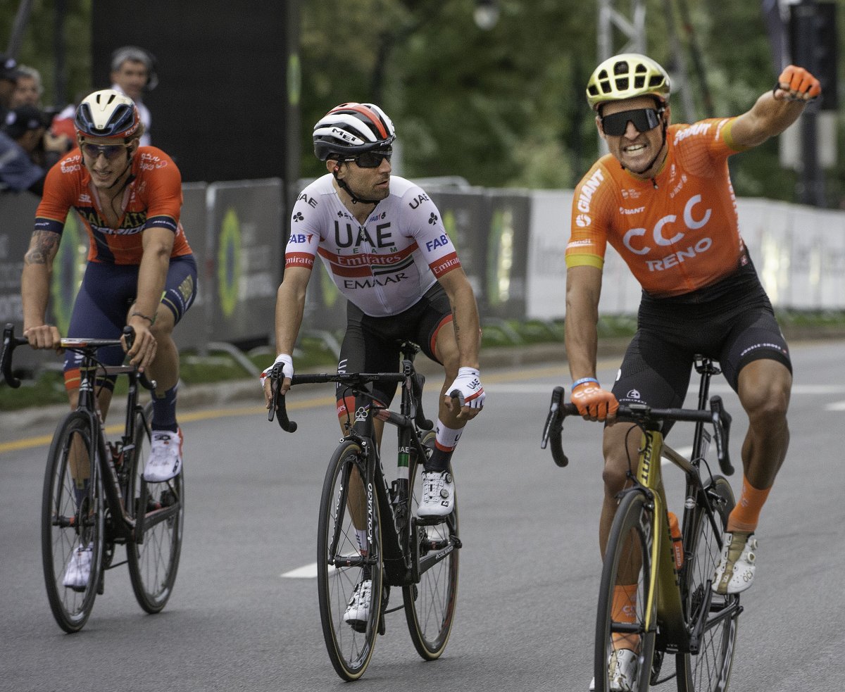 Greg Van Avermaet, right, who rides for UCI WorldTeam CCC, celebrates his victory as Diego Ulissi, middle, UCI WorldTeam UAE Team Emirates, and Iván Garcia, left, for UCI WorldTeam Bahrain–Merida look on at the finish of the Grand Prix Cycliste de Montréal on Sunday, September 15, 2019.