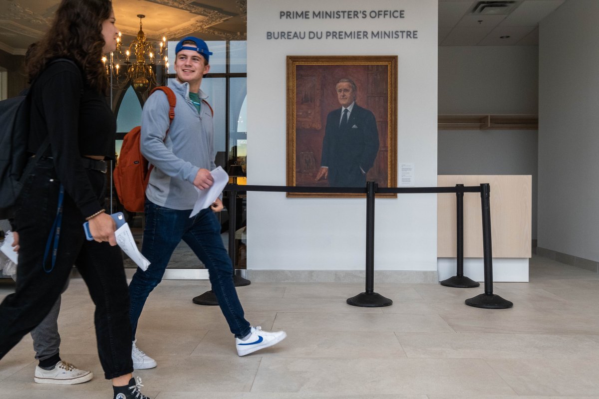Students at St. Francis Xavier University walk past a painting of former Prime Minister Brian Mulroney at the university's Brian Mulroney Institute of Government on Tuesday Sept. 17, 2019. 