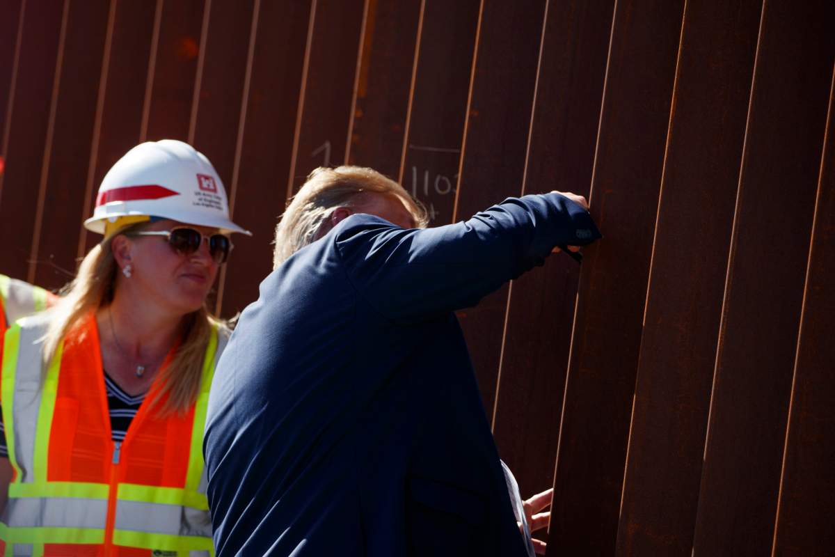 President Donald Trump signs his name as he tours a section of the southern border wall, Wednesday, Sept. 18, 2019, in Otay Mesa, Calif.