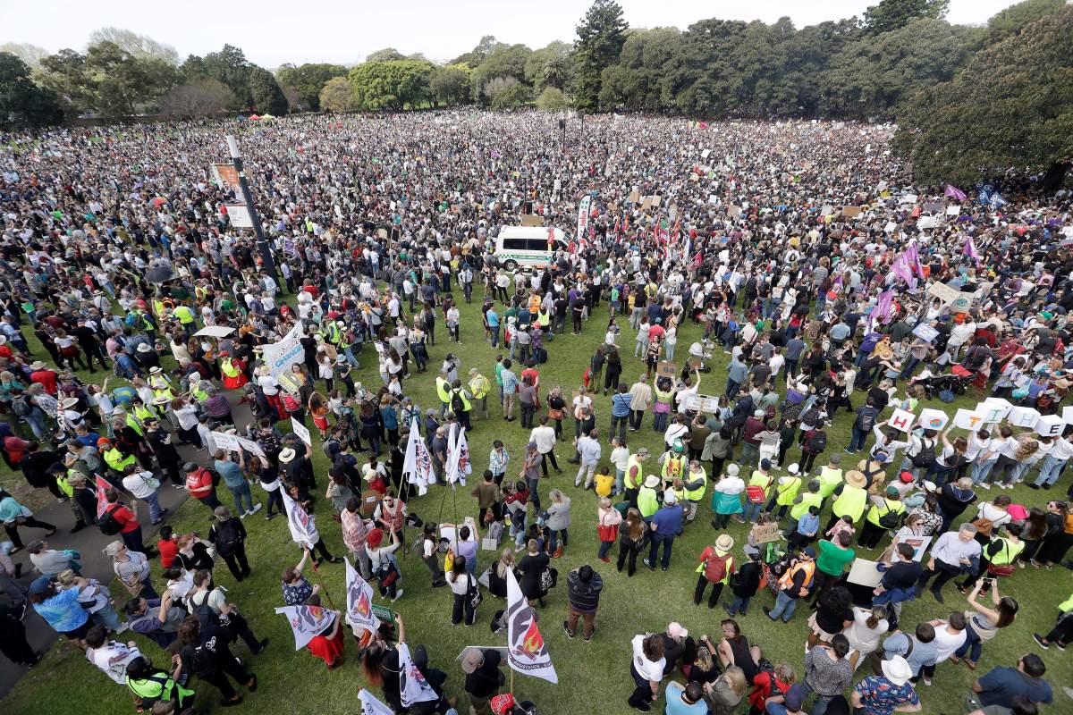 Thousands of protestors, many of them school students, gather in Sydney calling for action to guard against climate change. (AP Photo/Tiger Balsmeyer)