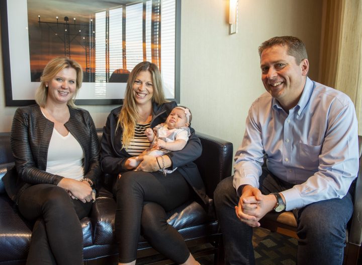 Conservative Leader Andrew Scheer, right, and his wife Jill, left, pose with Principal Secretary Kenzie Potter and her 9-week-old baby Georgia Hubick on the campaign trail in Mississauga, Ont., on Wednesday, Sept. 18, 2019. 
