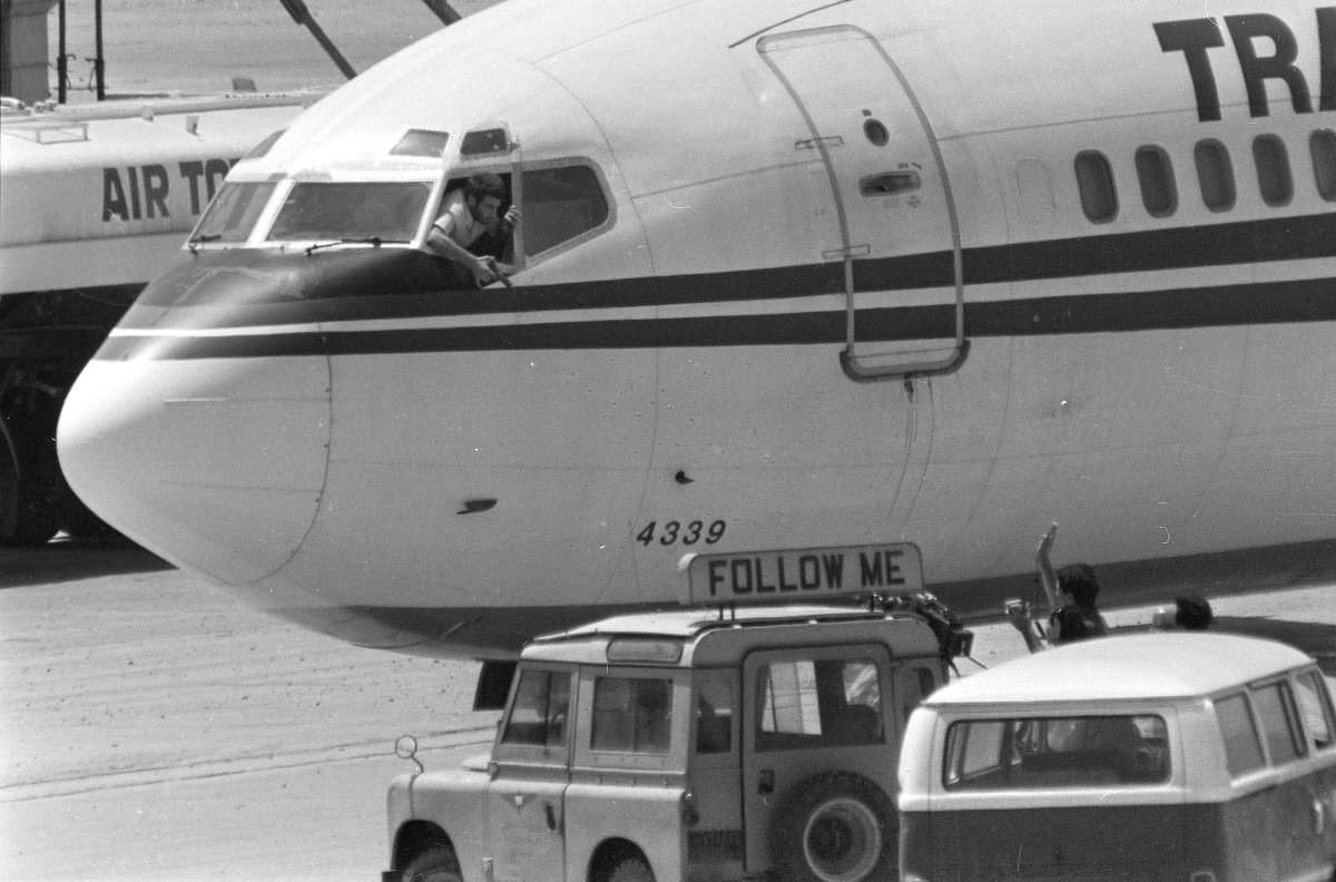 In this Wednesday, June 19, 1985 file photo, a hijacker points a weapon toward an ABC news media crew from the window of the cockpit of the Trans World Airlines jet as the American television crew approaches the jet for an interview at Beirut International Airport, Lebanon. 