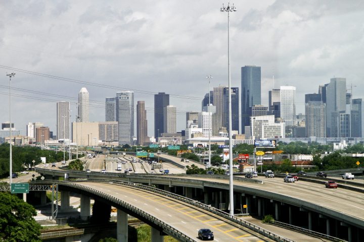 Cars travel along a highway with the skyline of downtown Houston in the background on May 20, 2010. 
