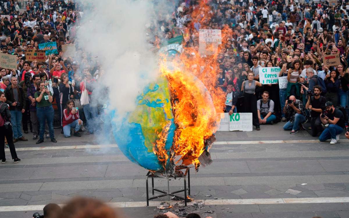 Students set fire to a replica of the planet Earth during a worldwide protest demanding action on climate change, in Milan, northern Italy, Friday, Sept. 27, 2019. The protests are inspired by Thunberg, who spoke to world leaders at a United Nations summit this week. ()