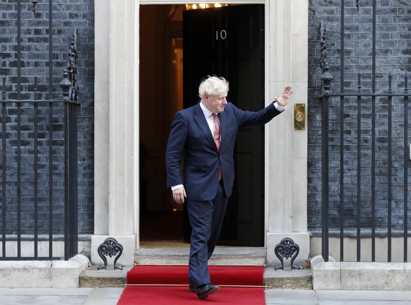 Britain's Prime Minister Boris Johnson waves to welcome the Emir of Qatar, Sheikh Tamim bin Hamad Al Thani at 10 Downing Street in London, Friday, Sept. 20, 2019 for bilateral talks.