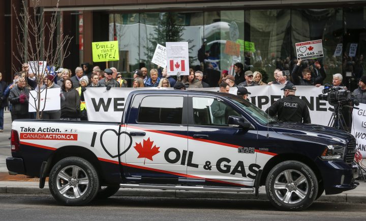 Pro-oil and gas supporters protest across the street as Federal Finance Minister Bill Morneau speaks to the Economic Club of Canada about the 2019 federal budget in Calgary, Alta., Monday, March 25, 2019.