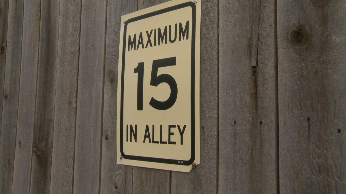 Speed limit sign posted at an alley in McKenzie Towne in Calgary .