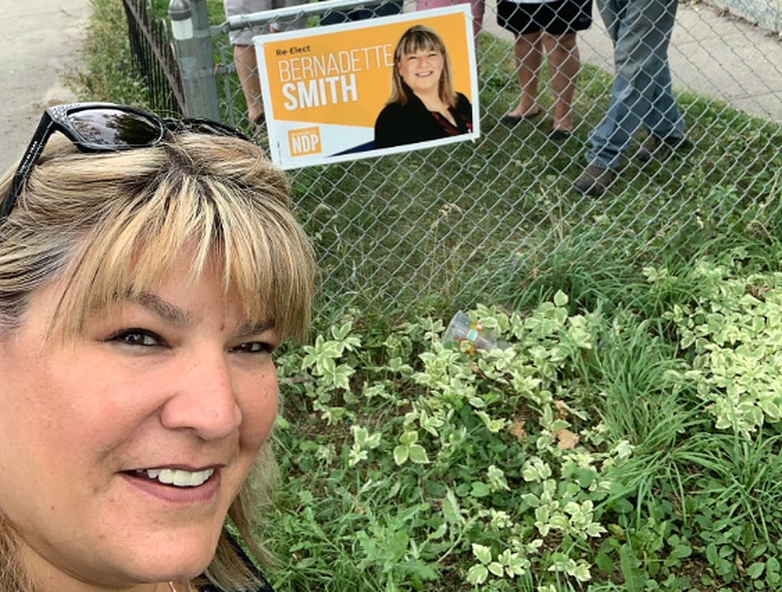 MLA Bernadette Smith poses with one of her signs during the 2019 election campaign.