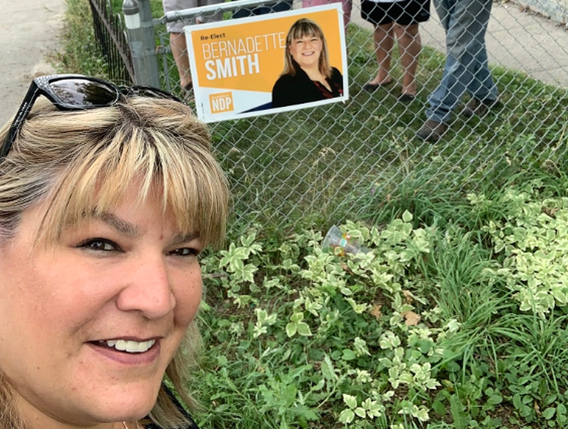 MLA Bernadette Smith poses with one of her signs. A similar sign was mistakenly placed on a Point Douglas man's fence - twice.