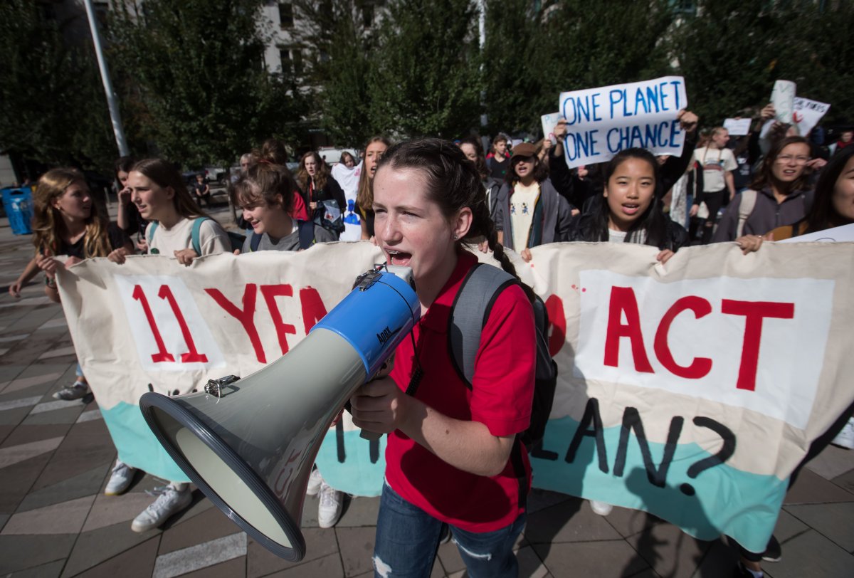 Young women lead a march after participating in a "die-in" climate action protest in Vancouver on Friday, Sept. 20, 2019.