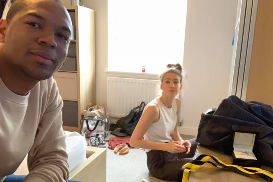 Edi Okoro, left, is shown with girlfriend Cally Read, who is unaware of the engagement ring hes hiding on the right.