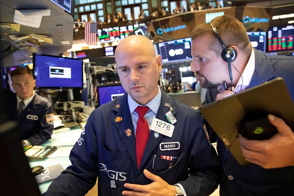 Mario Picone, center, and Michael Milano, right, work at the New York Stock Exchange, Monday, Sept. 16, 2019. U.S. stock markets rebounded at the open on Monday, March 2, even as Canadian stocks kept edging lower, after the worst trading week on both sides of the border since 2008.