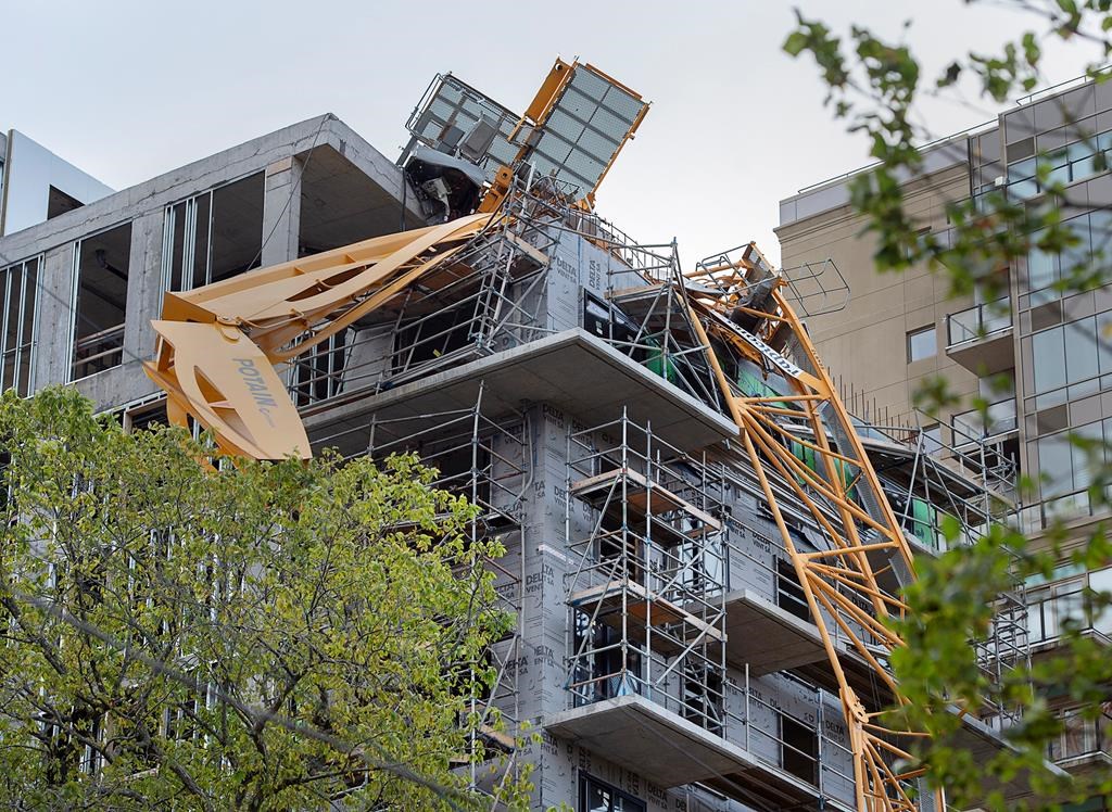 A toppled building crane is draped over a new construction project in Halifax on Sunday, Sept. 8, 2019.