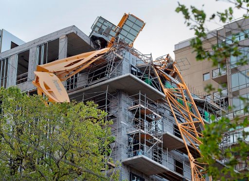 A toppled building crane is draped over a new construction project in Halifax on Sunday, Sept. 8, 2019. The Nova Scotia government says it is too soon to say who will pay the costs to remove a construction crane blown down during post-tropical storm Dorian. THE CANADIAN PRESS/Andrew Vaughan