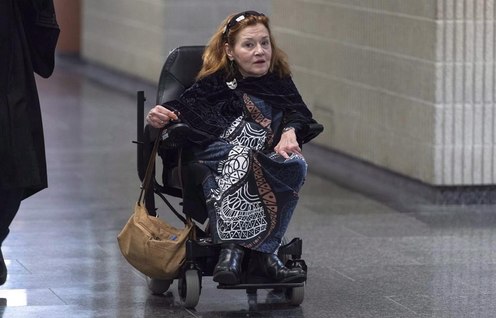 In this 2019 photo, Nicole Gladu arrives at the courthouse in Montreal 2019, for the beginning of a trial challenging the provincial and federal laws on medically assisted death on the grounds they are too restrictive. 