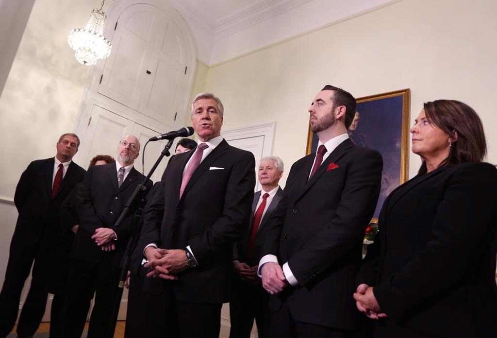 Newfoundland and Labrador Liberal Party Leader Dwight Ball, joined by members of his cabinet, Gerry Byrne, left to right, Perry Trimper, Eddie Joyce, Andrew Parsons and Siobahn Coady, speaks with the media after being sworn in as the province's 13th premier at Government House, in St. John's, N.L., on Monday, Dec. 14, 2015.