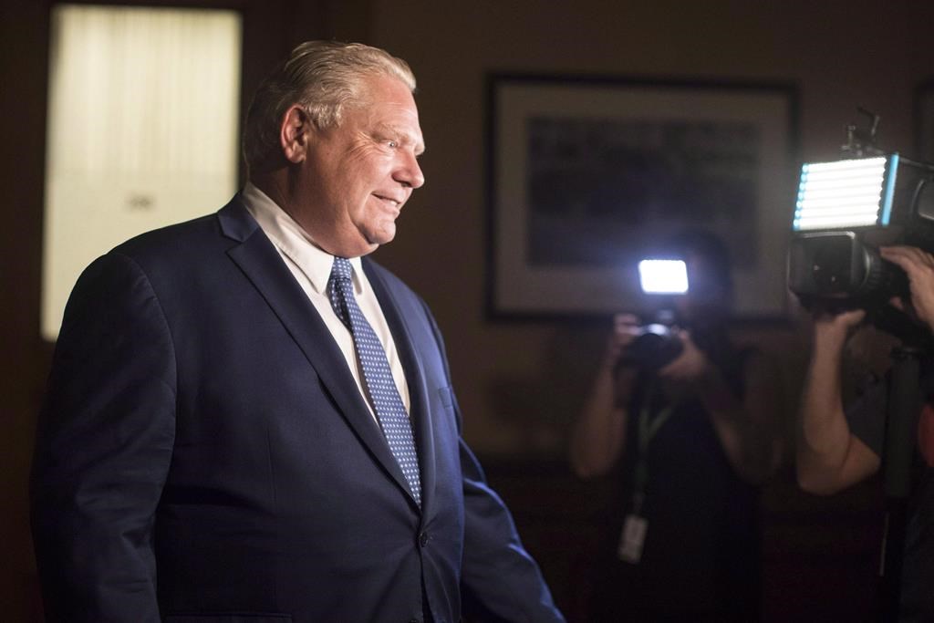 Ontario Premier Doug Ford makes his way to a press scrum.