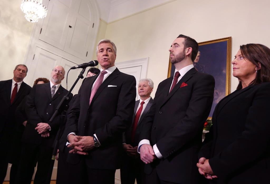Newfoundland and Labrador Liberal Party Leader Dwight Ball, joined by members of his cabinet, Gerry Byrne, left to right, Perry Trimper, Eddie Joyce, Andrew Parsons and Siobahn Coady, speaks with the media after being sworn in as the province's 13th premier at Government House, in St. John's, N.L., on Monday, Dec. 14, 2015.