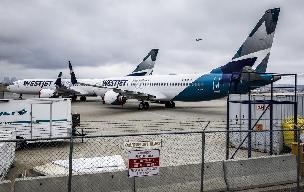 WestJet Airlines Ltd. says it is removing its grounded Boeing 737 Max jets from service until at least Jan. 5, affecting thousands of passengers with travel plans during the busy winter holiday season. Grounded WestJet Boeing 737 Max aircraft are shown at the airline's facilities in Calgary, Tuesday, May 7, 2019.