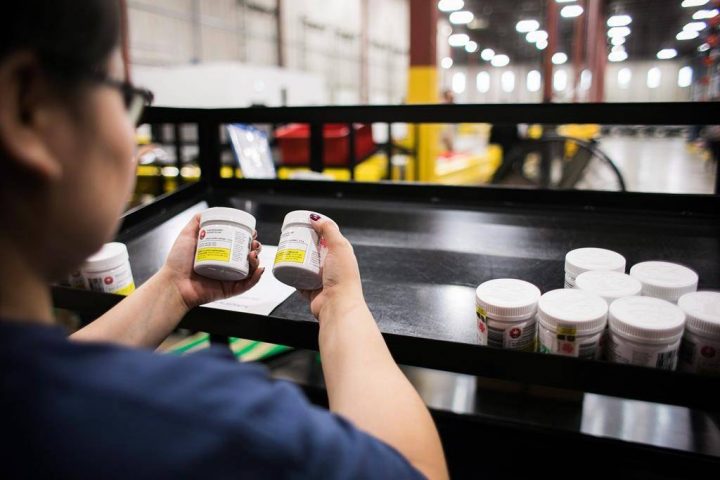 A worker examines cannabis products at the Ontario Cannabis Store distribution centre in an undated handout photo.