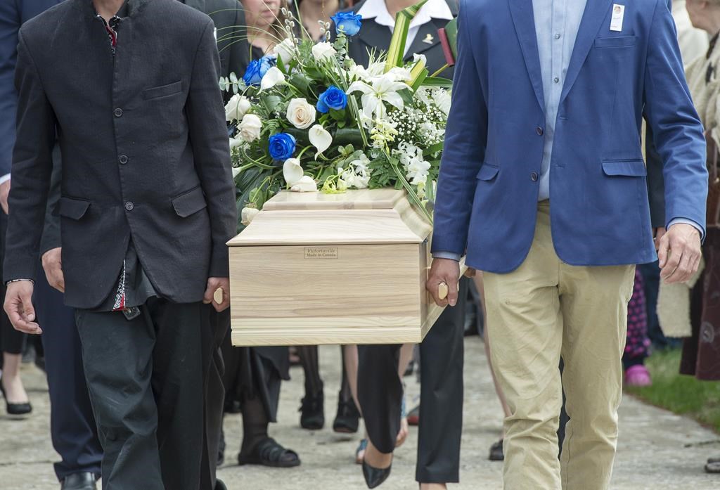 The casket of a seven-year-old girl who was found in critical condition inside of a home and later died is carried from the church after funeral services in Granby, Que., Thursday, May 9, 2019.