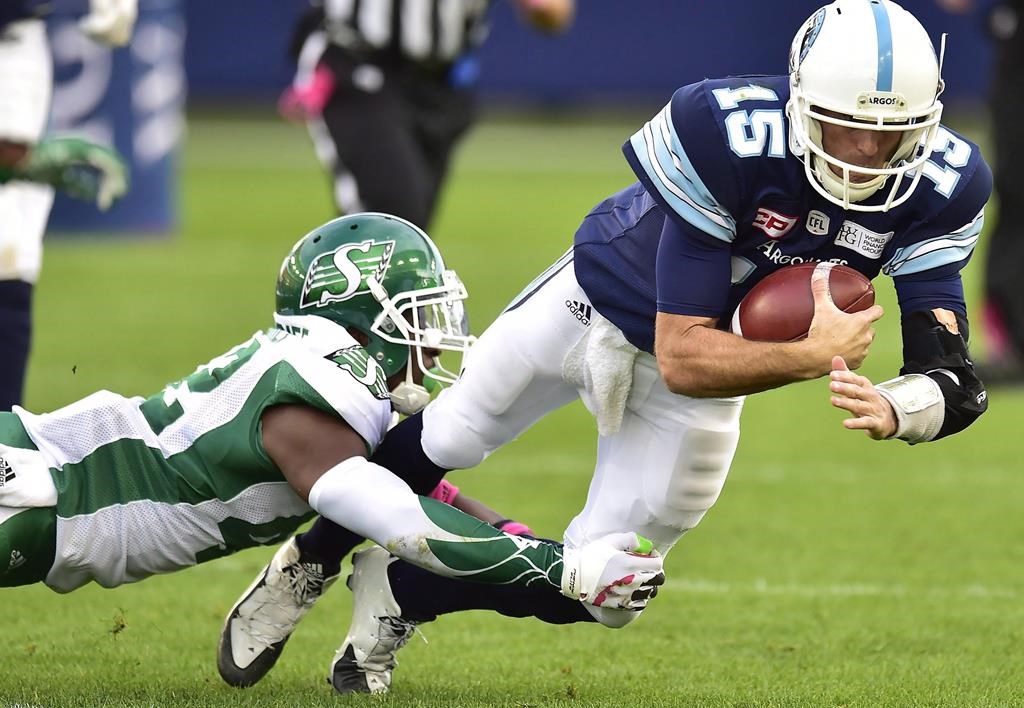 Toronto Argonauts quarterback Ricky Ray (15) dives with the ball as he's tackled by Saskatchewan Roughriders linebacker Derrick Moncrief (42) during second half CFL football action in Toronto on Saturday, October 7, 2017. It took three seasons, but Saskatchewan Roughriders linebacker Derrick Moncrief finally experienced his first Labour Day clash and it lived up to his lofty expectations. THE CANADIAN PRESS/Frank Gunn.
