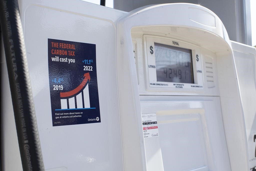 A gas pump displays an anti-carbon tax sticker in Toronto on Thursday, August 29, 2019. A civil rights group is asking the courts to declare an Ontario law mandating anti-carbon tax stickers on gas pumps to be illegal.