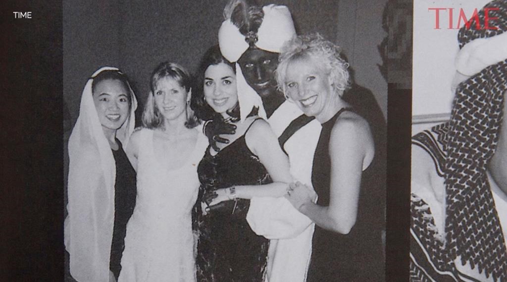 A photo showing Prime Minister Justin Trudeau, second from right, at a 2001 costume party — his hands and face blackened with makeup — was published by Time Magazine Wednesday. THE CANADIAN PRESS HANDOUT – TIME
