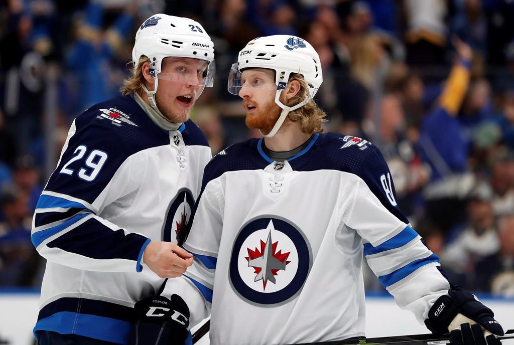Winnipeg Jets' Patrik Laine (29), of Finland, and Kyle Connor (81) talk during the third period in Game 6 of an NHL first-round hockey playoff series against the St. Louis Blues, Saturday, April 20, 2019, in St. Louis. Laine and Connor are ready to make up for missing most of training camp by slotting onto the NHL Jets roster for the team's regular-season opener in New York against the Rangers on Thursday. THE CANADIAN PRESS/AP/Jeff Roberson.