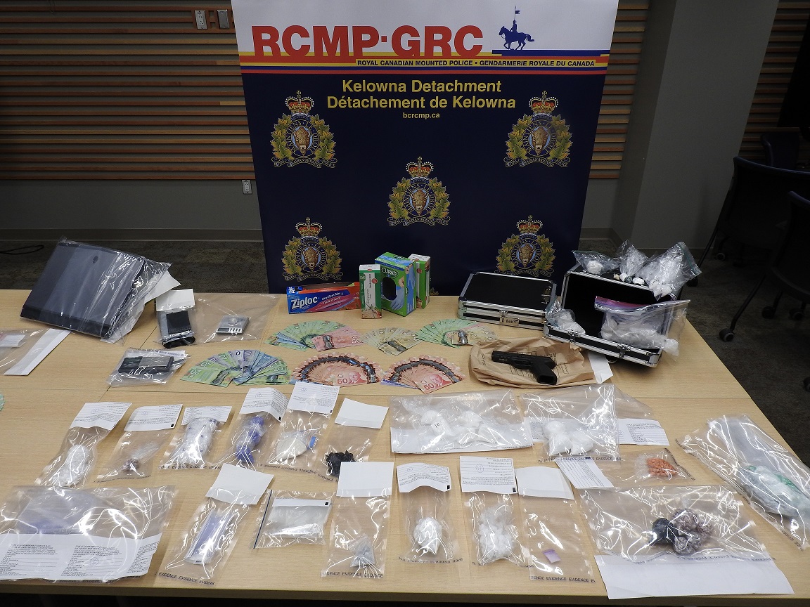 Kelowna RCMP display the drugs, gun and cash they seized in a recent drug bust at two different locations.