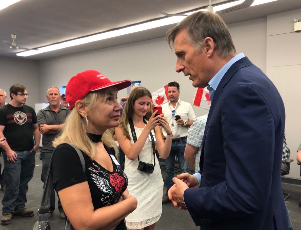 Peoples Party of Canada Maxime Bernier and pre-campaign event in London speaking to supporter in a Make America Great Again hat .