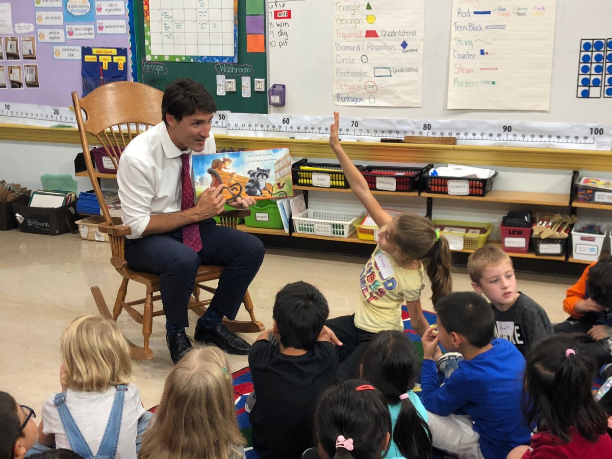 Liberal Leader Justin Trudeau reading a book called Why I Love Canada to a group of students at Blessed Sacrament Elementary School in London.
