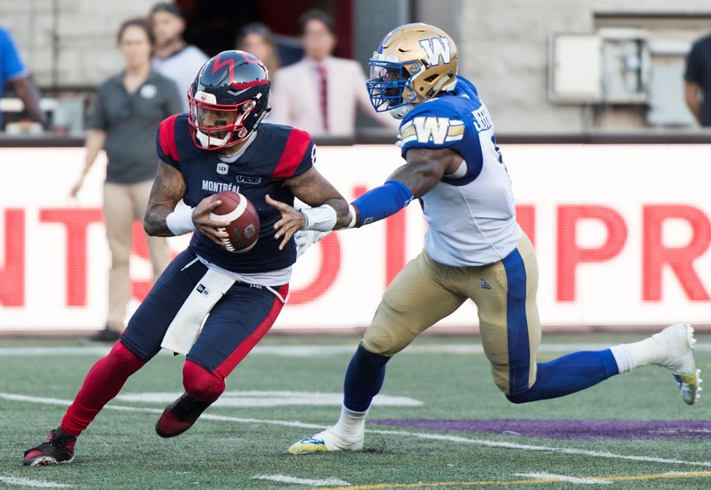 Montreal Alouettes quarterback Vernon Adams Jr., left, breaks away from Winnipeg Blue Bombers linebacker Adam Bighill during second half in Montreal, Sept. 21, 2019. The CFL is reviewing the helmet-swinging incident Saturday involving Adams Jr. and Bighill.