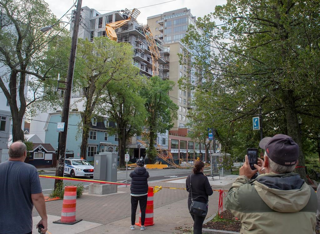 A toppled building crane is draped over a new construction project in Halifax on Sunday, Sept. 8, 2019. Hurricane Dorian brought wind, rain and heavy seas that knocked out power across the region, left damage to buildings and trees as well as disruption to transportation.