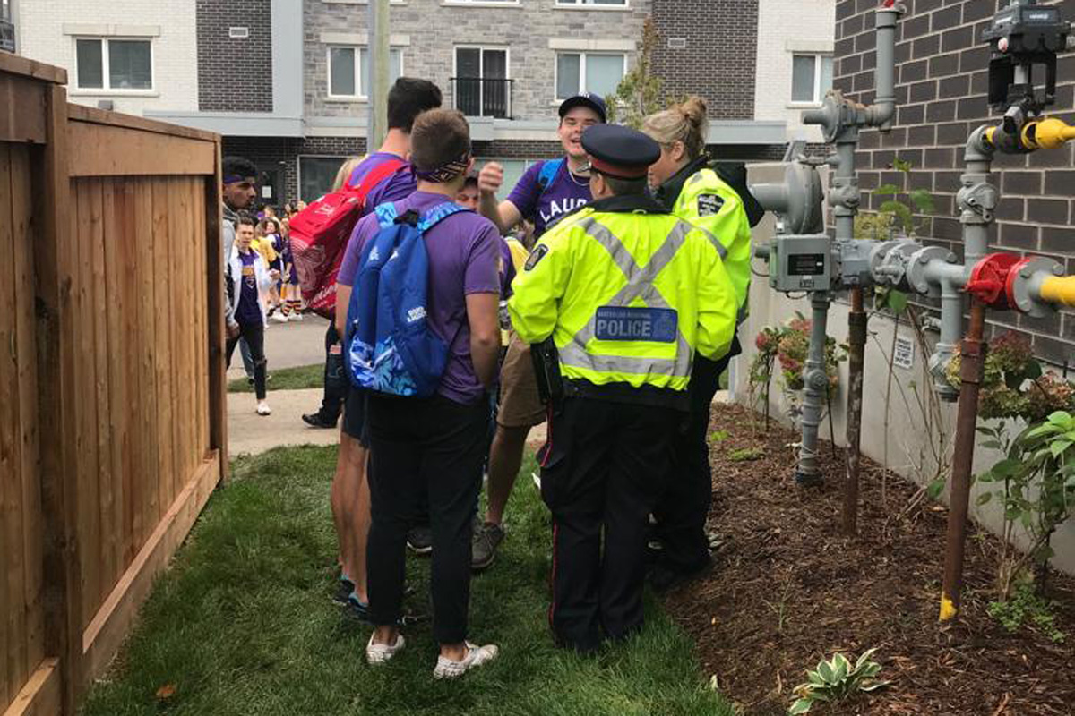 Waterloo Regional Police talk to revellers at Laurier's homecoming celebration.