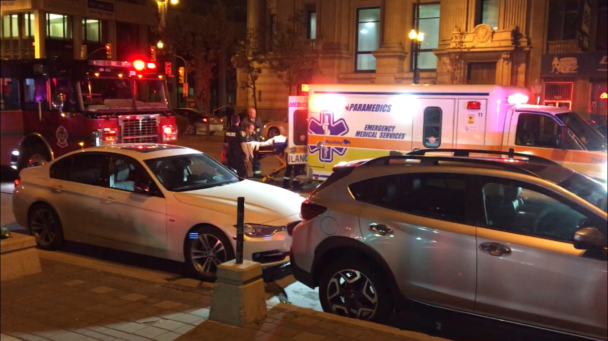 Paramedics transporting a victim to hospital following an incident at a Portage Avenue apartment building.