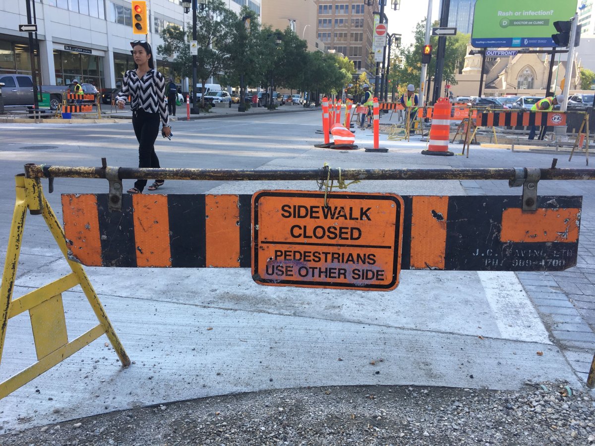 Both sides of the sidewalk are being torn apart at the corner of Graham Avenue and Garry Street.