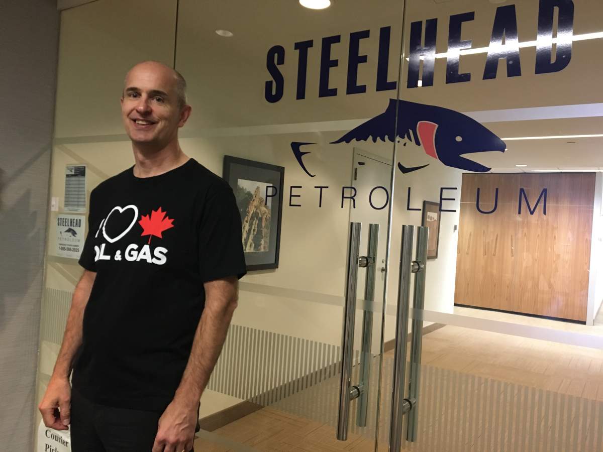 William Lacey wears his I HEART CANADIAN OIL & GAS T-shirt at his Calgary office.