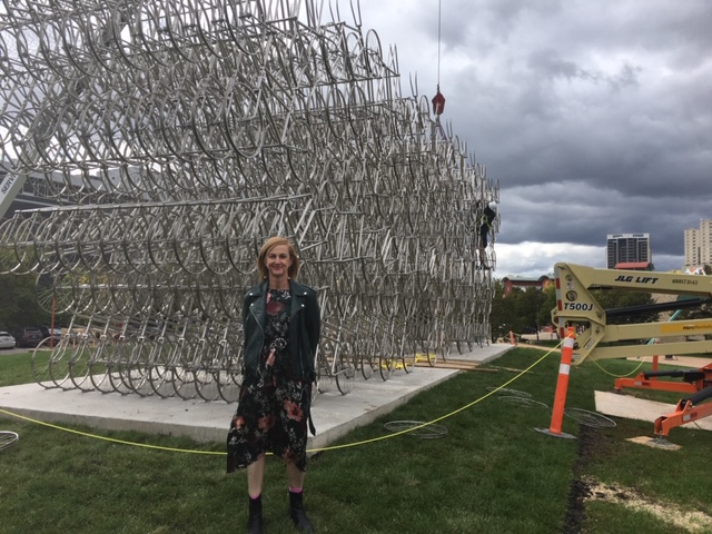 Clare MacKay, executive director of The Forks Foundation, standing in front of “Forever Bicycles”, an art installation by internationally renowned artist and political dissident Ai Weiwei.
