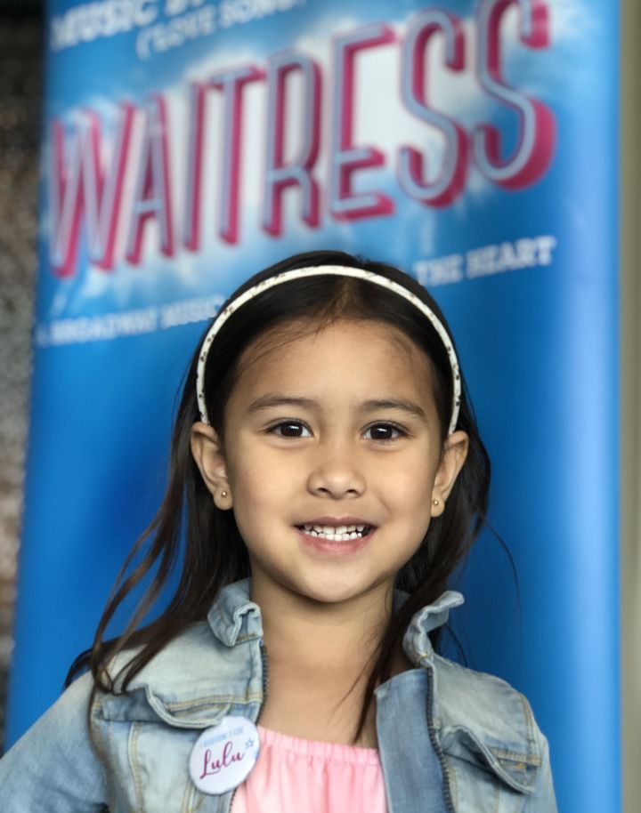 4 year old Ella Sophia Bashford is all smiles as she waits for her turn to audition for the role of Lulu in the Broadway musical Waitress playing in Calgary in November